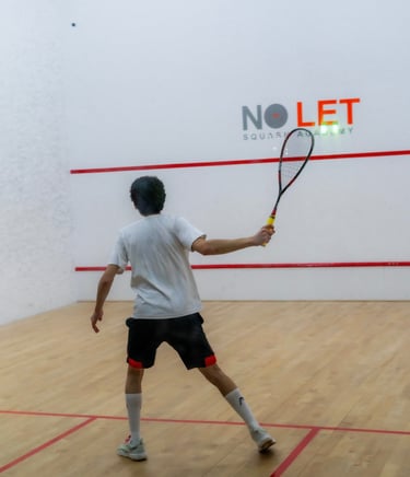 a man in a white shirt is playing squash