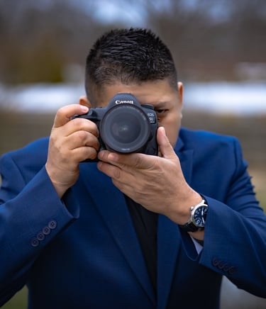 a man in a suit and a watch on his camera