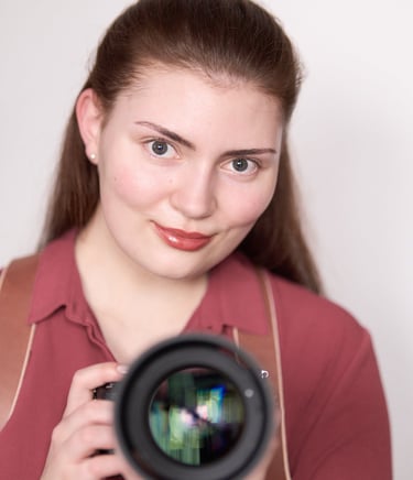 a woman holding a camera and taking a picture