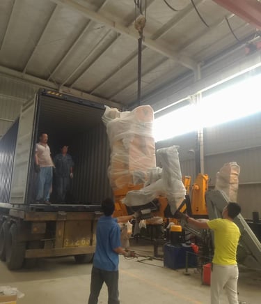 The workers are loading the truck mounted crane into the container