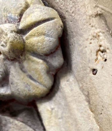 Extreme detail shot of a Victorian flower ornament painted to look like sandstone.