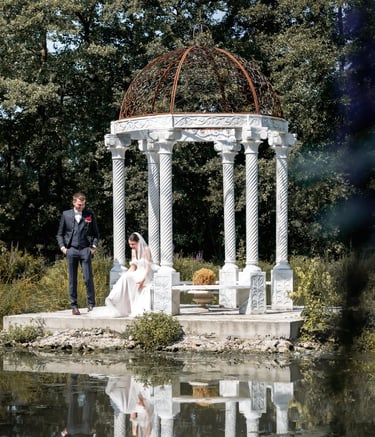 a bride and groom standing in front of a gazeboar
