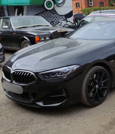 an Enlab black bmw m4 coupe with a black and white car