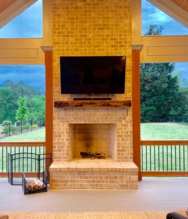 outdoor tv and soundbar mounted on a brick fireplace