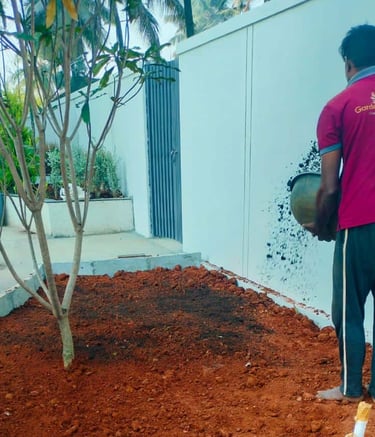 Landscape execution team shaping garden terrain and installing features by Garden Designers