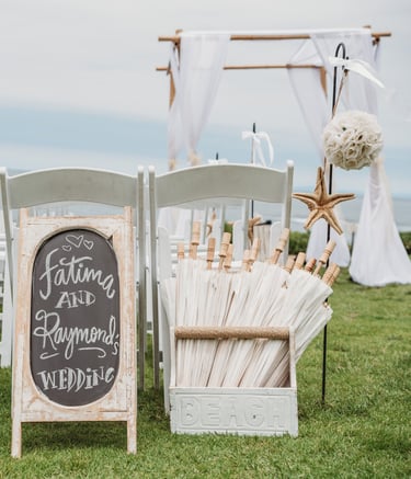 off white paper hangers in box at beach wedding set up