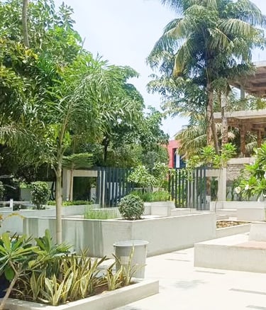 Employee-friendly corporate exterior with walking paths and greenery by Garden Designers