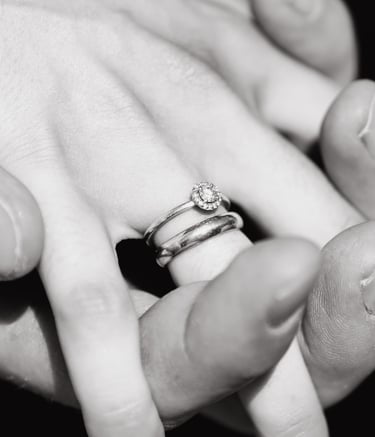 a person holding a ring with a diamond ring