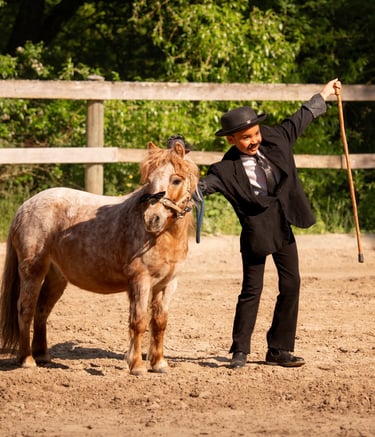 a girl in a suit and hat standing next to a horse