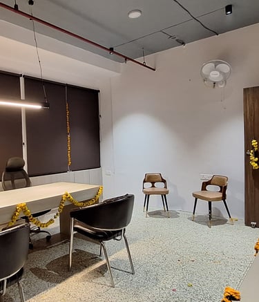 a room with a desk and chairs and a table