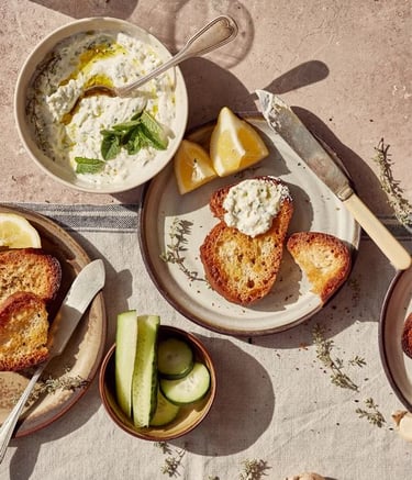Tzatziki with toasted bread and fresh herbs-a dish prepared by the chefs of Villa Eats in Naxos 