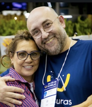a man and woman are smiling and hugging