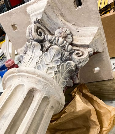 Close-up on a Victorian capital painted in faux sandstone.