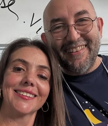 a man and woman smiling and posing for a picture