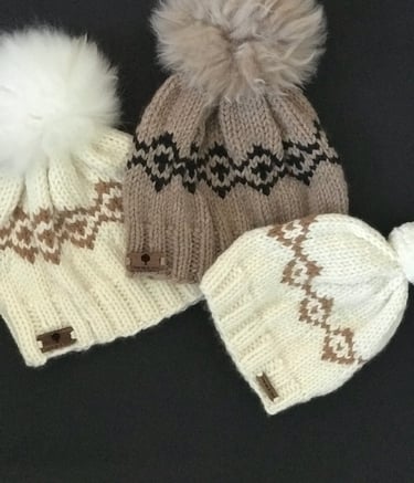 Three knitted hats with pom pom pom 