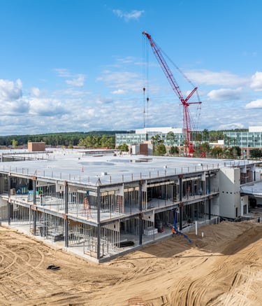 a crane is in the foreground of a construction site