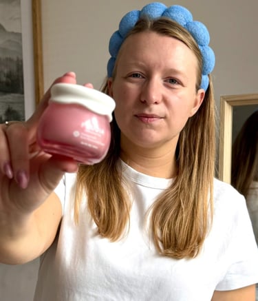 a woman in a white shirt  holding a jar of cream UGC