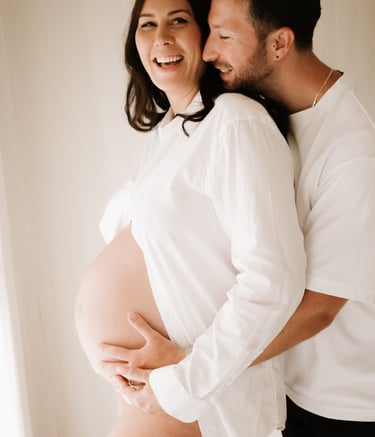 matenrigy couple photo holding baby bump, taken in studio Littlehampton