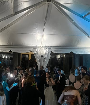 a group of people standing around a tent