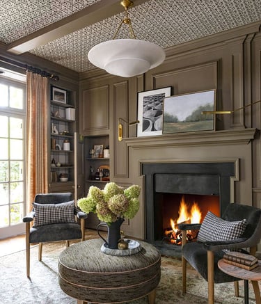 a living room with a fireplace and chairs