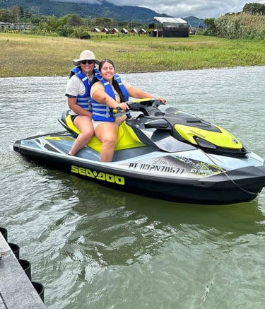 a woman and a man riding a jet skis