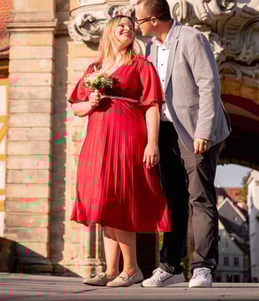 a bride and a groom standing in front of a building