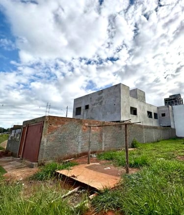 a building with a fenced in area with grass