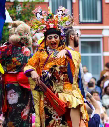 a person dressed in traditional Japanese outfit dancing in the Amsterdam Pride Parade