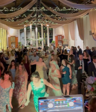 a group of people dancing at a wedding