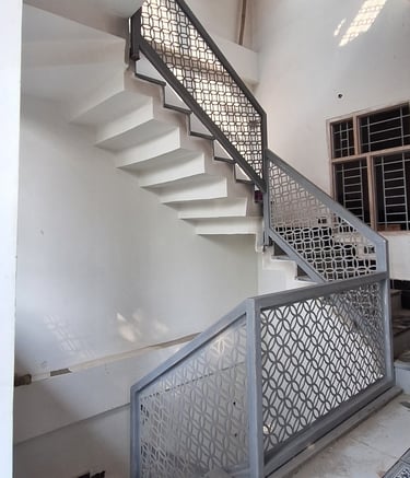 a staircase with a metal railing and a metal railing