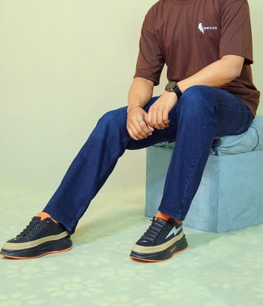 a man sitting on a blue stool with his feet on a stool