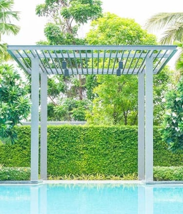 Modern pergola structure creating shade in garden by Garden Designers