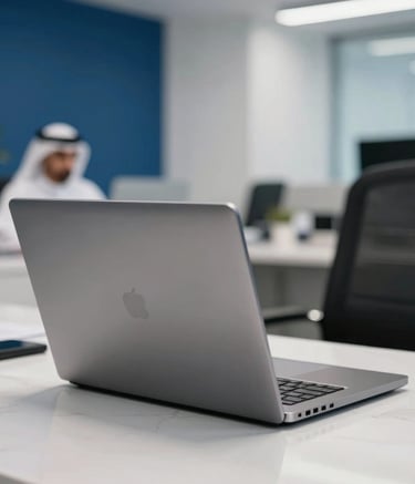 A close-up photograph of a high-end laptop on a white marble desk in a modern Middle Eastern / Gulf corporate office. The background is softly blurred with deep blue and white decor, creating a professional and trustworthy atmosphere.