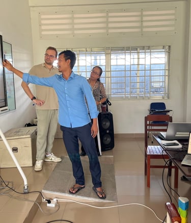 a man standing in front of a large screen teachning