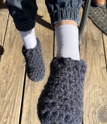a person wearing slippers and socks with a pair of slippers