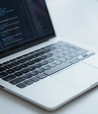 A close-up of a sleek, minimalist tech workstation featuring a laptop with lines of clean code. The scene is shot with a shallow depth of field, using cool lighting tones of #A1C6D0 and #F8FBFD to evoke a sense of precision and reliability.