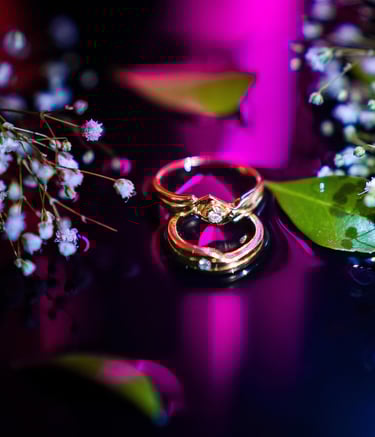 two wedding rings with flowers and a bouquet