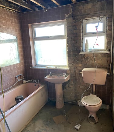 a derelict bathroom with a toilet and a sink