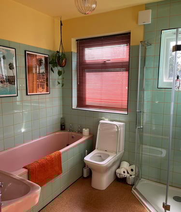 a bathroom with a pink bathtub and a pink bathtub