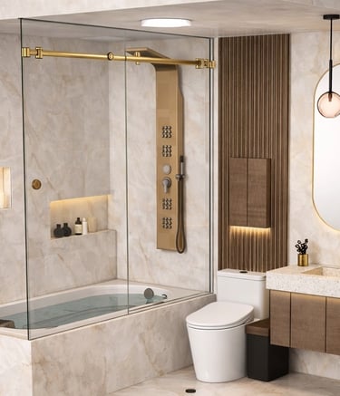 Luxury modern bathroom with marble tile, gold shower fixtures, glass tub enclosure, and backlit mirror.