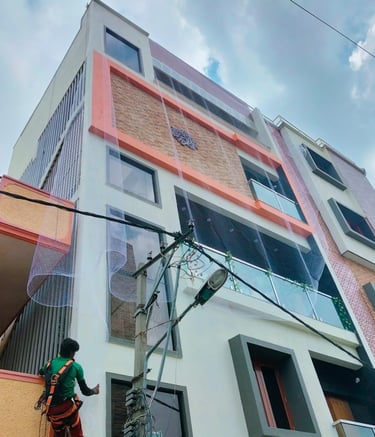 Finished pigeon net installation on a Bellandur apartment balcony at sunset.