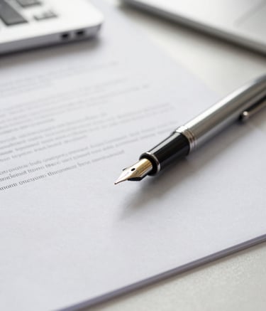 A sophisticated close-up of a fountain pen and professional business documents on a light grey desk in a bright Cardiff office. The lighting is soft and natural, conveying a sense of transparency and meticulous financial planning. British professional context.