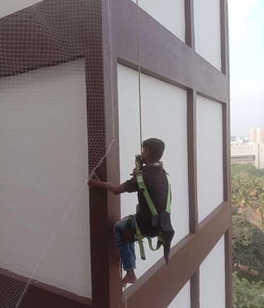 Technician carefully measuring balcony dimensions for net installation