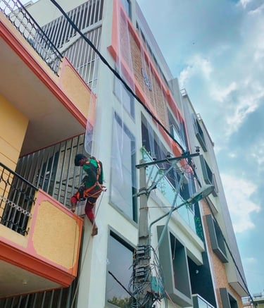 Wide-angle shot showing multiple balconies with installed safety nets in a residential complex.