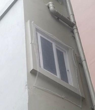 Pigeon netting fitted neatly over an apartment duct area.