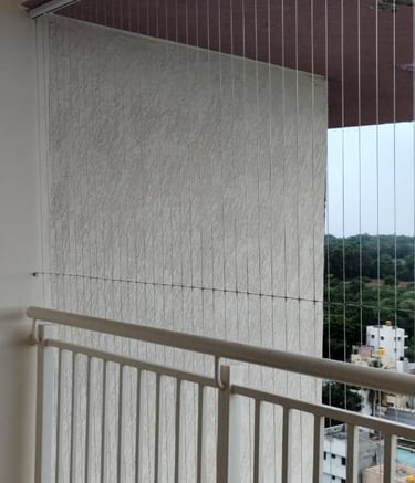 Close-up of a sleek invisible grill seamlessly fitted on a Royapettah balcony.