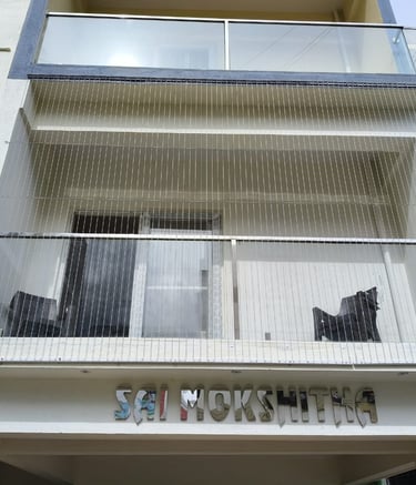 Close-up of a sleek invisible grill installed on a T Nagar balcony, blending seamlessly with the sur