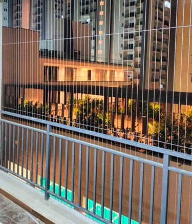 Close-up of sleek invisible grills seamlessly fitted on a Besant Nagar balcony.