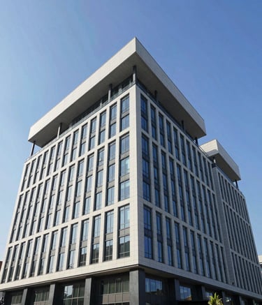 A low-angle architectural photograph of a modern commercial office building in a North American business park, featuring a clean and complex flat roofing system against a clear blue sky, demonstrating professional industrial construction.