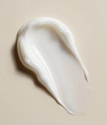 A macro photography shot of a thick, luxurious white skincare cream texture with soft ridges, set against a soft beige background in a high-end North American / US clinical laboratory setting. The lighting is soft and clinical, highlighting the viscosity and premium quality of the product.